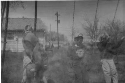 Children playing in the back yard of the family of Walter Mueller on Faculty Lane in Seward, Nebraska. The image was scanned from a photograph belonging to Toby Beck.
