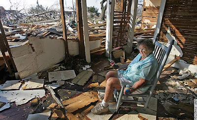 Elderly woman sadly observes hurricane damage