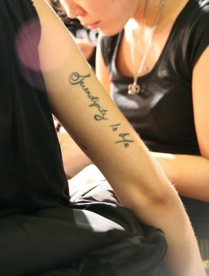 This Too Shall Pass on the inside of her upper right arm