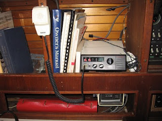 Shelf next to Uniflite electrical panel showing VHF radio (working) and engine hours meter (not working) Shelf next to Uniflite electrical panel showing VHF radio (working) and engine hours meter (not working)