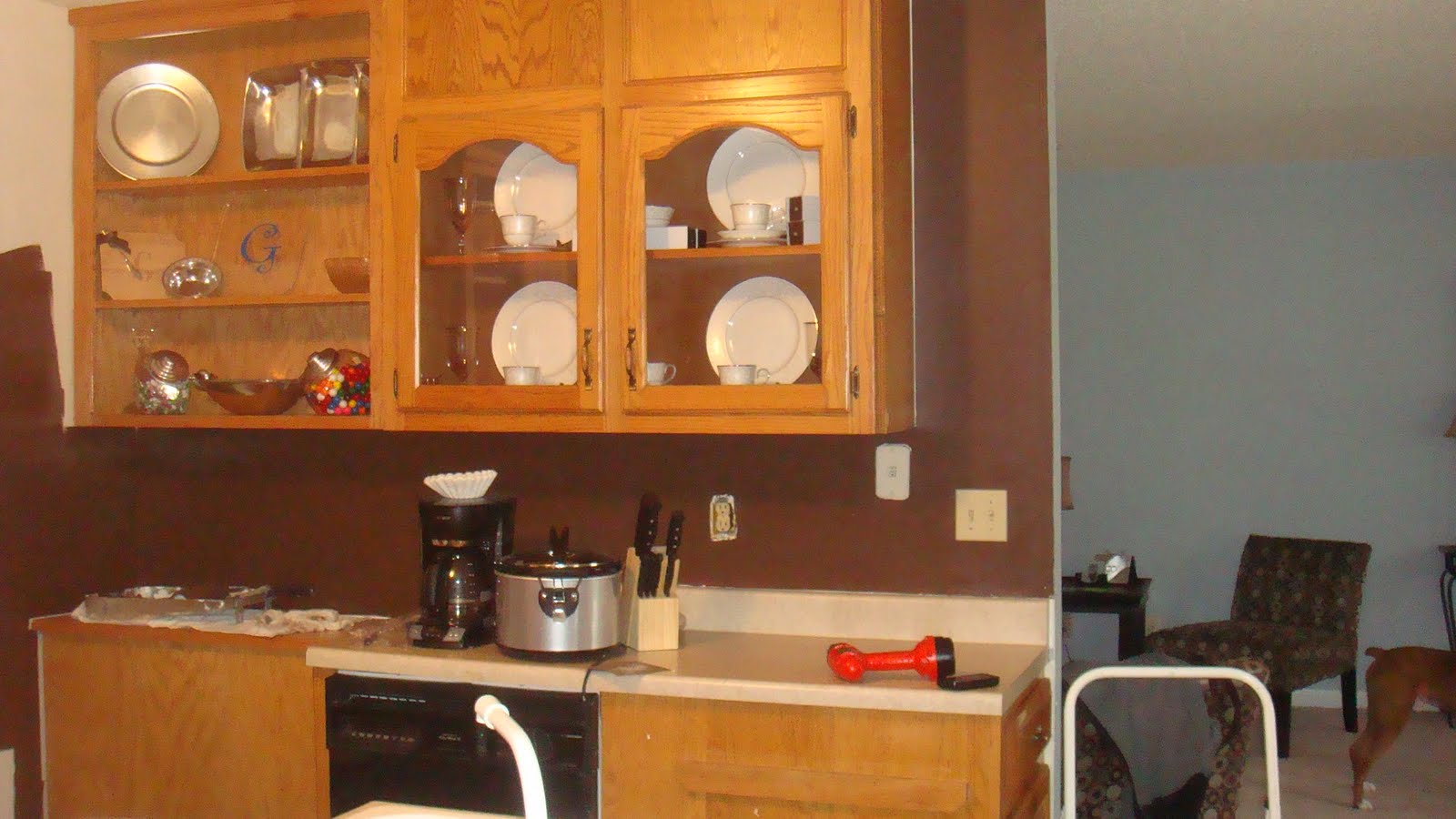 Mirrored kitchen backsplash behind some shelving was MORE WALLPAPER! Seriously lady (who lived