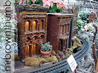 model train garden houses surrounded by poinsettias