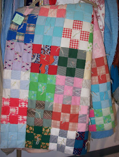 nine patch quilt made with many different colored polyester fabrics