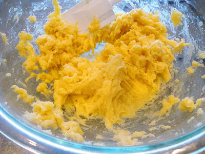 cream puff dough being mixed in a glass bowl with a spatula