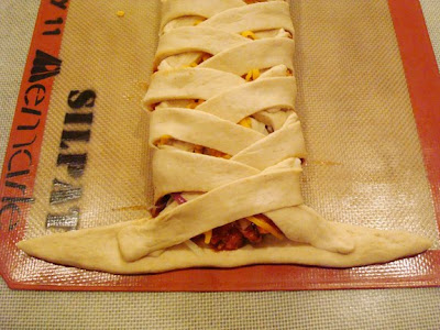 braided bread dough with two strips that still need folded in