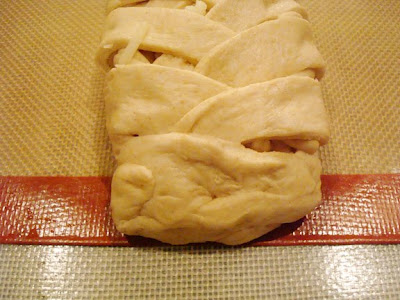 the end of braided bread dough loaf