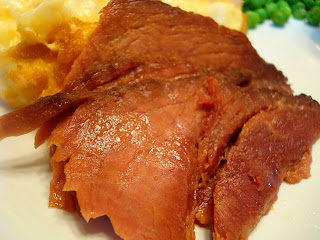 a chunk of ham on a white plate