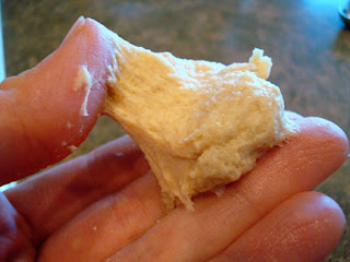 pinching a piece of dough in between thumb and middle finger