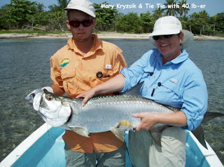 Photo of Mango Creek Lodge guide Tie-Tie, Mary, and a large tarpon