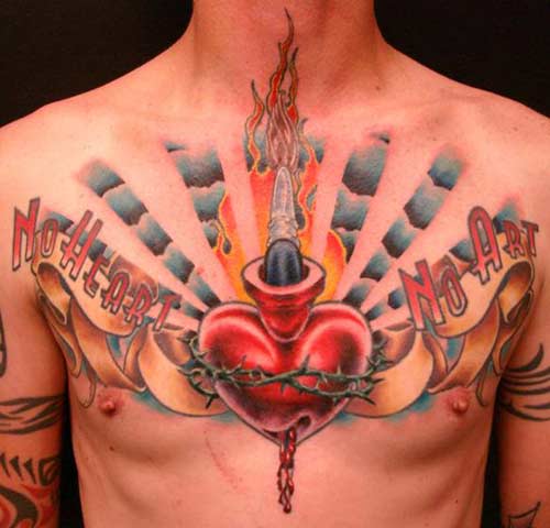 Big red sacred tattoo heart stabbed with daggers on a man's chest.