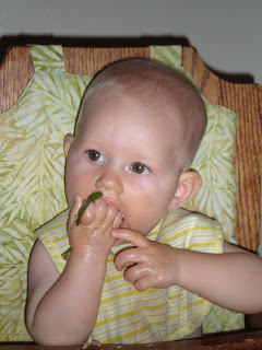 baby eating green bean