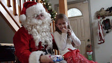 Kaymin telling Santa how good she has been.