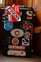 a black suitcase with stickers