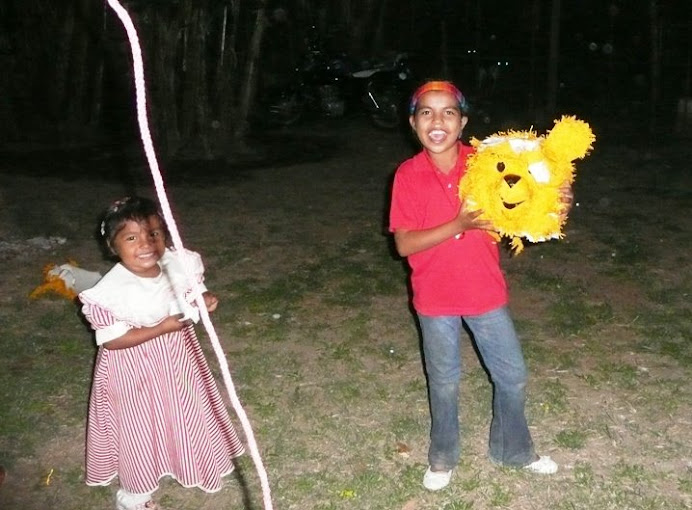 Milagro and Rosita with the head of Pooh-the-pinata