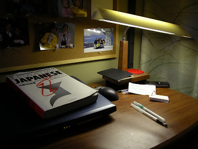 My desk, with computer, lamp, and Japanese language book