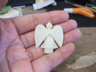 Glue them to the back of the doll with more water