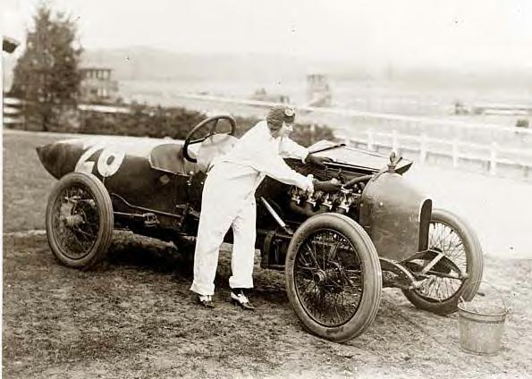 Woman working on Stutz Weightman Special #26 on Benning race track, Washington, DC 1916