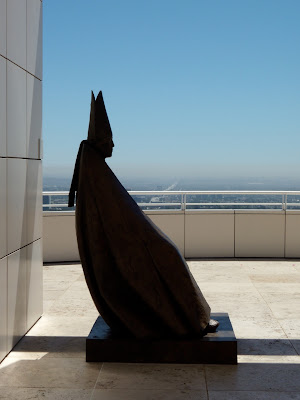 Seated Cardinal sculpture in silhouette at The Getty