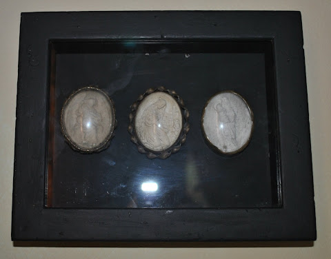 A set of meerschaum sculptures under glass