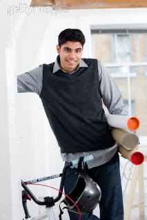 Young man with bicycle in office