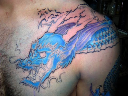 Dragon tattoo on his sleeve. This tattoo design using blue ink.