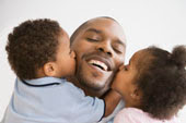 Children kissing their father, Fotosearch.com