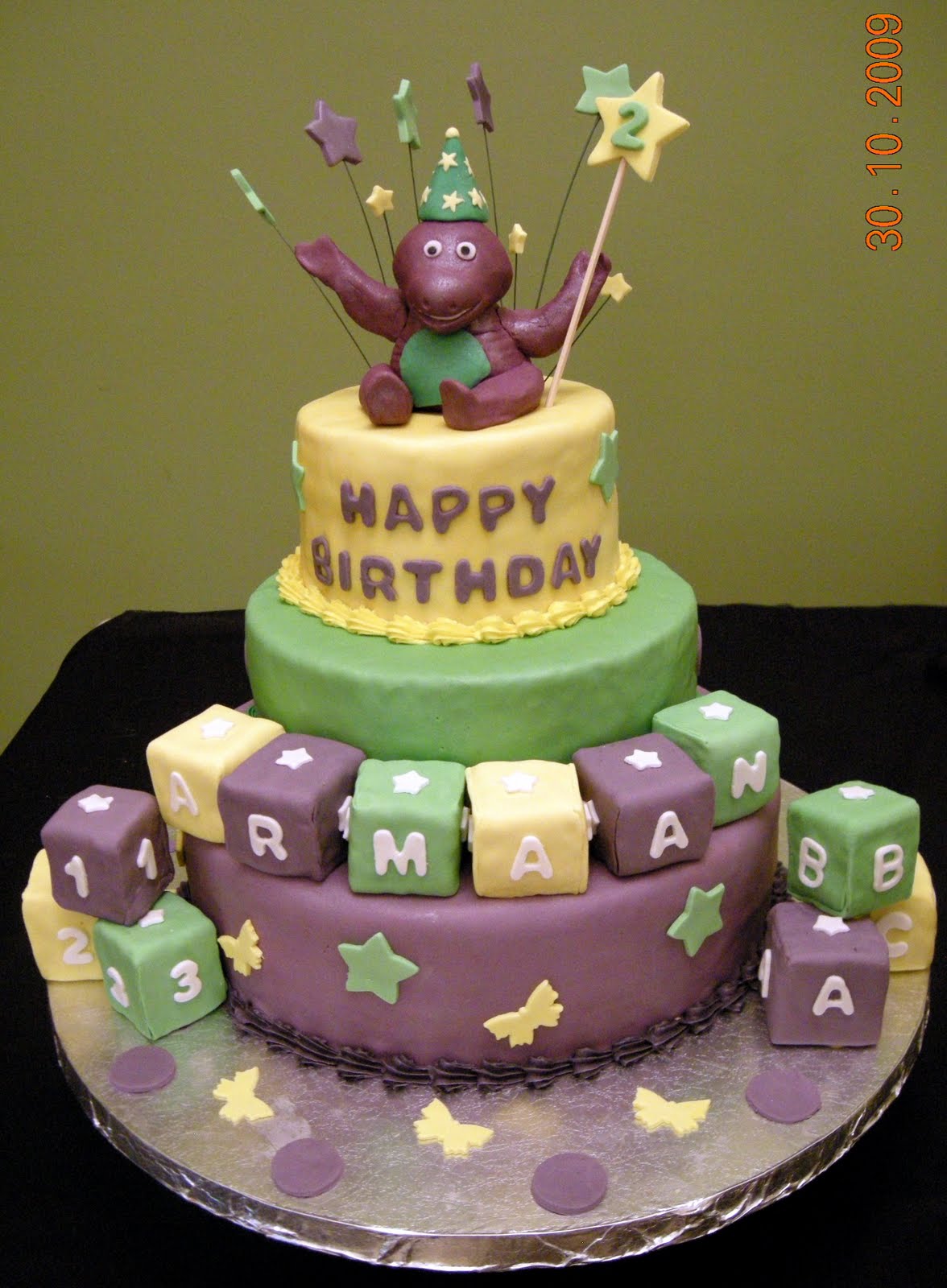 Harshi's Cakes & Bakes 3 Tier Barney Cake Harshi's Cakes & Bakes 3 Tier Barney Cake