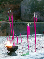 incense at foot of Buddha