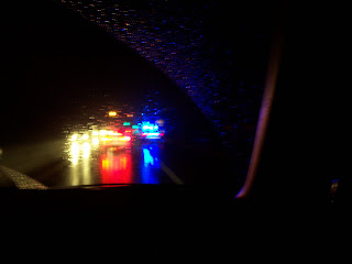 blurry lights through rainy windshield