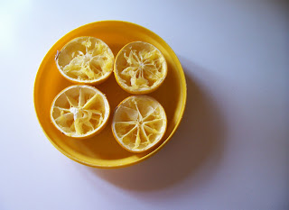 Eaten oranges on yellow plate Daily photo project