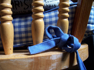 Macro wooden chair seat and dowels with blue gingham checkered cushion and small blue bow