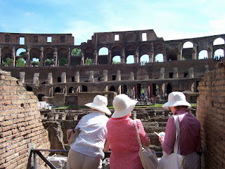 Three ladies with white hats in the Coliseum Rome, Italy