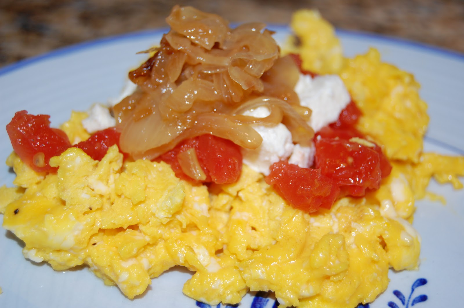 Scratch.Love Scrambled Eggs topped with Feta, Tomatoes and Caramelized Onions