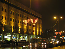 lit up menorahs in street