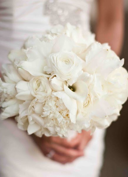 a soft romantic bridal bouquet in shades of white and cream with lots of 