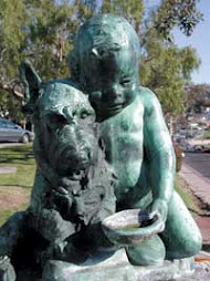 Boy with Dog Bronze Statue at Jahraus Park in Laguna Beach, CA