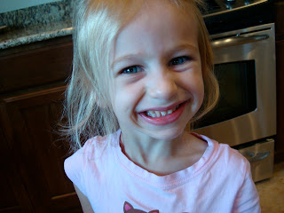 Close up of young girl smiling in kitchen