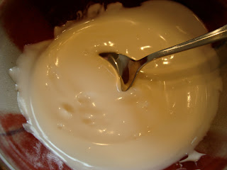 Melted white chocolate stirred with spoon