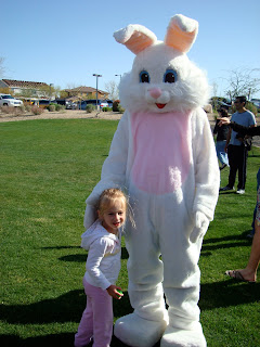 Young girl standing next to Easter Bunny