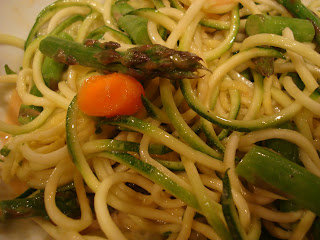 Close up of Zuke Noodles tossed with asparagus, carrots, and cumbers