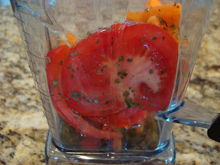 Side of blender with ingredients for marinara sauce