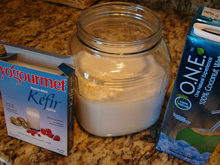 Keifir Starter and Coconut water containers mixed together in large glass jar