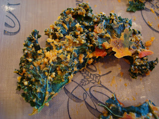 Kale chips on pans with orange veggies