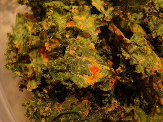 Dehydrated Kale Chips stacked in clear container