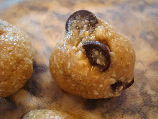 Up close of Raw Vegan Chocolate Chip Cookie Dough Ball showing chocolate chips sticking out
