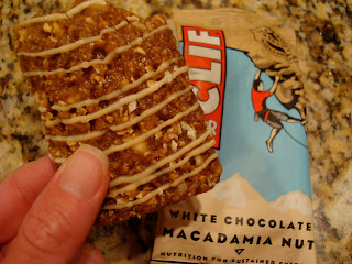 Hand holding White Chocolate Macadamia Nut Clif Bar