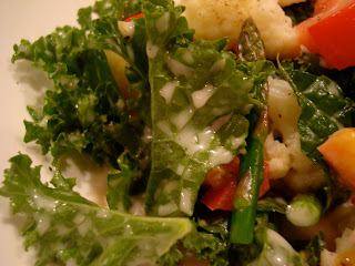 Up close of kale leaf dripping with homemade Vegan Slaw Dressing