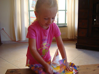 Young girl wearing pink unwrapping presents