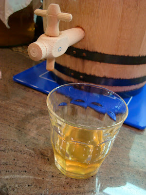 Oak barrel tap with glass of kombucha