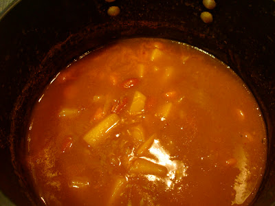 Boiling Savory Pumpkin, Potato, and Carrot Soup in pot